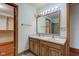 Bathroom featuring double sinks, wooden cabinets, and combination tub and shower, leading to closet at 528 Wind Skip Cir, Westfield, IN 46074