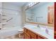 Bathroom features a tub and shower combination, ceramic tile, safety bars and a wood vanity at 528 Wind Skip Cir, Westfield, IN 46074