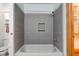 Bathroom featuring tile shower and tub, and cabinet for storage, and access to large closet at 528 Wind Skip Cir, Westfield, IN 46074