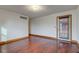Bedroom features hardwood floors, baseboard trim, fresh neutral paint, and sliding door at 528 Wind Skip Cir, Westfield, IN 46074