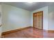 Simple bedroom featuring hardwood floors, a closet, and neutral walls at 528 Wind Skip Cir, Westfield, IN 46074