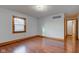Bright bedroom with hardwood floors, baseboard trim, a double-hung window, and fresh neutral paint at 528 Wind Skip Cir, Westfield, IN 46074