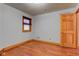 Bedroom with hardwood floors, a window, and a wooden door at 528 Wind Skip Cir, Westfield, IN 46074