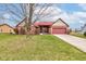 Charming brick home with red roof, an attached two-car garage and well-manicured lawn at 528 Wind Skip Cir, Westfield, IN 46074