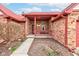 Covered front porch with red railings and brick pillars offering a cozy and inviting entrance at 528 Wind Skip Cir, Westfield, IN 46074