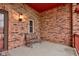 Relaxing front porch with bench, lantern, and brick walls offering a charming outdoor space at 528 Wind Skip Cir, Westfield, IN 46074