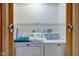 This cozy laundry room features newer model Maytag washer and dryer units with a wire shelf above at 528 Wind Skip Cir, Westfield, IN 46074