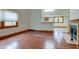 Cozy living room with a fireplace, hardwood floors, and natural light from a window at 528 Wind Skip Cir, Westfield, IN 46074