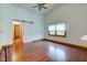 Bright living room featuring hardwood floors, a ceiling fan, and a sliding barn door at 528 Wind Skip Cir, Westfield, IN 46074