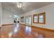 Open-concept living room with vaulted ceiling, hardwood floors, natural light, and access to the kitchen at 528 Wind Skip Cir, Westfield, IN 46074