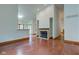 Open-concept living room with fireplace, hardwood floors and access to other rooms at 528 Wind Skip Cir, Westfield, IN 46074