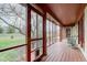 The wooden-floored screened porch offers outdoor living with natural light, green scenery, and furniture at 528 Wind Skip Cir, Westfield, IN 46074