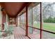 The long screened porch features beautiful outdoor views, cozy seating, and natural light at 528 Wind Skip Cir, Westfield, IN 46074