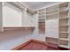 Walk-in closet features custom shelving and storage, with wood floors and painted trim and drawers at 528 Wind Skip Cir, Westfield, IN 46074