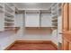 Walk-in closet features custom shelving and storage, with wood floors and painted trim at 528 Wind Skip Cir, Westfield, IN 46074
