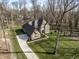 Aerial view of the brick home on its verdant lot, highlighting the long driveway and mature trees at 552 E 82Nd St, Indianapolis, IN 46240
