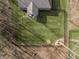 Aerial view of the backyard showcasing the expansive lawn, fire pit, and secure fencing at 552 E 82Nd St, Indianapolis, IN 46240