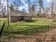 Spacious, well-maintained backyard featuring a secure fence and mature trees offering privacy at 552 E 82Nd St, Indianapolis, IN 46240