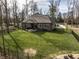 An overview of the backyard which shows the lush green grass and brick home at 552 E 82Nd St, Indianapolis, IN 46240
