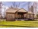 Backyard view with covered patio featuring comfortable seating, enhancing the property's outdoor living space at 552 E 82Nd St, Indianapolis, IN 46240