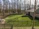 Lush backyard features a covered patio, fenced perimeter, and mature trees, enhancing outdoor enjoyment at 552 E 82Nd St, Indianapolis, IN 46240
