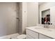 Modern bathroom showcasing a tiled shower, sleek vanity with white countertop, and a walk-in closet at 552 E 82Nd St, Indianapolis, IN 46240