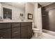 Modern bathroom with gray vanity, contemporary fixtures, and tiled shower at 552 E 82Nd St, Indianapolis, IN 46240