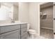 Stylish bathroom with gray vanity, modern fixtures, white subway tile and convenient walk-in closet at 552 E 82Nd St, Indianapolis, IN 46240