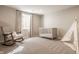 Cozy Bedroom with a rocking chair, crib, and teepee, creating a warm and inviting space at 552 E 82Nd St, Indianapolis, IN 46240