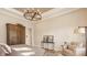 Bright bedroom with decorative chandelier, and comfortable seating area at 552 E 82Nd St, Indianapolis, IN 46240