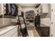 Walk-in closet with custom shelving and storage, mirrored surface, and dark chest of drawers at 552 E 82Nd St, Indianapolis, IN 46240
