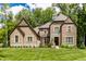 Beautiful brick two-story home with a well-manicured lawn and professionally landscaped front yard at 552 E 82Nd St, Indianapolis, IN 46240
