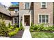 Close up view of the brick home's stone front entrance, featuring a well-manicured garden at 552 E 82Nd St, Indianapolis, IN 46240