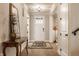 Inviting hallway with a decorative table, and a bright white door leading to the exterior at 552 E 82Nd St, Indianapolis, IN 46240