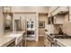 Well-equipped kitchen with stainless steel appliances, custom cabinets, and a view into the dining area at 552 E 82Nd St, Indianapolis, IN 46240
