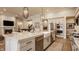 Open kitchen with a large island, stainless steel appliances, and views of the living room and fireplace at 552 E 82Nd St, Indianapolis, IN 46240