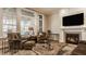 Bright living room with a fireplace, seating, large windows, and natural light at 552 E 82Nd St, Indianapolis, IN 46240