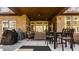 Large covered patio with an outdoor kitchen, dining area, lounge furniture, and ceiling fan at 552 E 82Nd St, Indianapolis, IN 46240