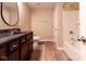 Bathroom with dark wood vanity, countertop and shower-tub combination with stylish hardware at 5786 Blue Sky Dr, Whitestown, IN 46075