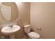 Half bathroom features include a pedestal sink, and a round mirror at 5786 Blue Sky Dr, Whitestown, IN 46075
