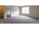 This bedroom features neutral walls and carpet, with a window offering plenty of natural light at 5786 Blue Sky Dr, Whitestown, IN 46075