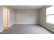 A bright bedroom features neutral walls, plush carpeting, and a window letting in natural light at 5786 Blue Sky Dr, Whitestown, IN 46075