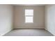 Bedroom with neutral walls and carpet flooring, enhanced by a window that provides natural light at 5786 Blue Sky Dr, Whitestown, IN 46075