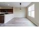 Dining area featuring gray wood-look floors, pendant lighting, and bright windows at 5786 Blue Sky Dr, Whitestown, IN 46075