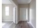 Bright foyer with gray wood-look flooring, white trim, and natural light at 5786 Blue Sky Dr, Whitestown, IN 46075