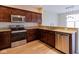 This modern kitchen is equipped with stainless steel appliances and attractive granite countertops at 5786 Blue Sky Dr, Whitestown, IN 46075
