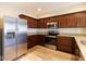 A modern kitchen featuring stainless steel appliances and granite countertops provides efficient cooking space at 5786 Blue Sky Dr, Whitestown, IN 46075
