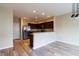 Open-concept kitchen featuring stainless steel appliances and granite countertops overlooking the dining area at 5786 Blue Sky Dr, Whitestown, IN 46075
