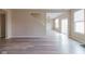 Spacious living room featuring gray wood-look floors and bright, neutral walls at 5786 Blue Sky Dr, Whitestown, IN 46075