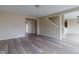 Open concept living room with gray wood-look floors and neutral walls at 5786 Blue Sky Dr, Whitestown, IN 46075